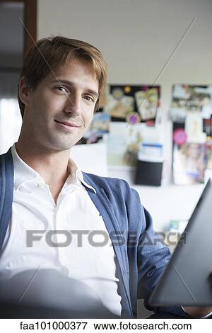 Man using digital tablet in office View Large Photo Image Stock Photo - Man using digital tablet in office. Fotosearch
