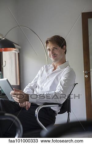 Stock Image - Man using digital tablet. Fotosearch