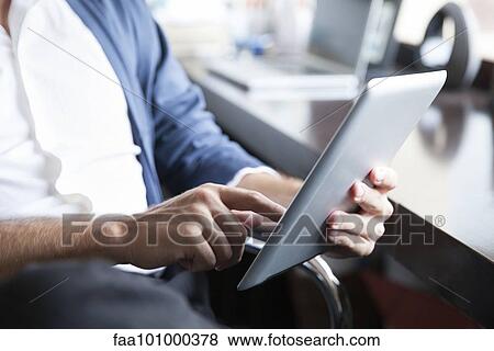 Stock Photo - Man using digital tablet. Fotosearch