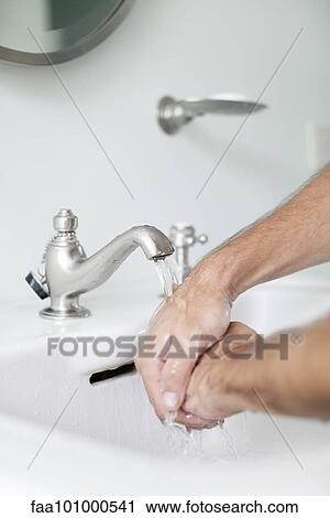 Man washing hands in bathroom sink View Large Photo Image Stock Image - Man washing hands in bathroom sink. Fotosearch