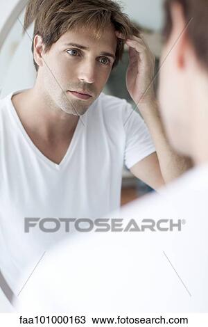 Man with receding hairline looking at self in mirror View Large Photo Image Stock Image - Man with receding hairline looking at self in mirror. Fotosearch