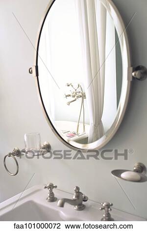 Stock Image - Mirror above bathroom sink. Fotosearch