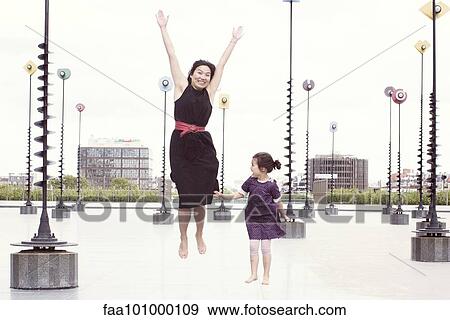 "Mother and daughter jumping in front of whimiscal sculptures, La Defense, Paris, France" View Large Photo Image Stock Photo - "Mother and daughter jumping in front of whimiscal sculptures, La Defense, Paris, France". Fotosearch