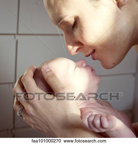 Stock Image - Mother bonding with newborn baby. Fotosearch