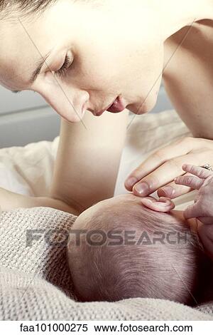 Stock Photography - Mother comforting newborn baby. Fotosearch
