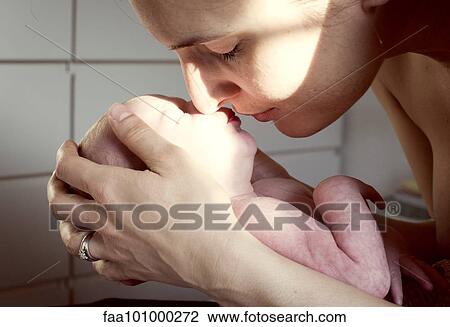 Mother nuzzling newborn baby View Large Photo Image Stock Image - Mother nuzzling newborn baby. Fotosearch