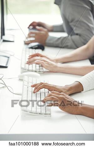 Office workers using computer keyboards View Large Photo Image Stock Photo - Office workers using computer keyboards. Fotosearch