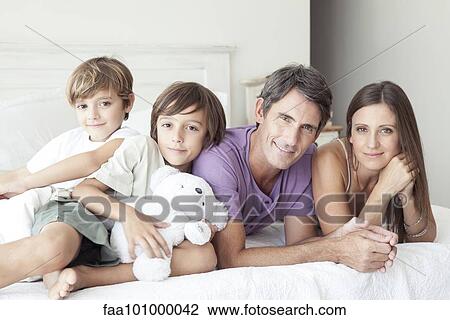 Stock Image - "Parents with young boys, portrait". Fotosearch