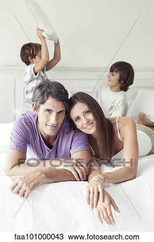 Stock Image - "Parents with young boys, portrait". Fotosearch