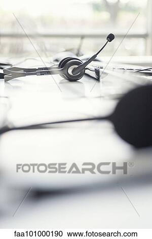 Stock Image - Phone headset on desk. Fotosearch