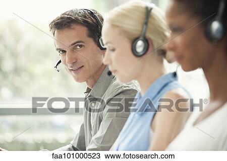 Professionals working in call center View Large Photo Image Stock Image - Professionals working in call center. Fotosearch