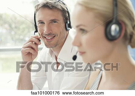 Professionals working in call center View Large Photo Image Stock Photograph - Professionals working in call center. Fotosearch