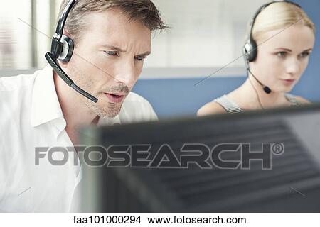 Sales associates working in call center View Large Photo Image Picture - Sales associates working in call center. Fotosearch