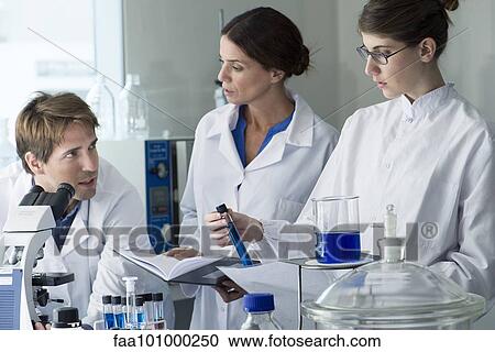 Scientists conducting experiment in laboratory View Large Photo Image Stock Image - Scientists conducting experiment in laboratory. Fotosearch