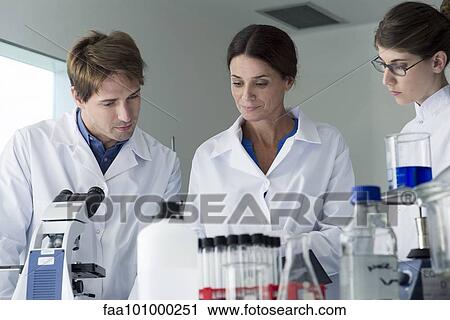 Scientists conducting experiment in laboratory View Large Photo Image Stock Image - Scientists conducting experiment in laboratory. Fotosearch