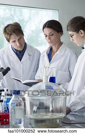 Scientists conducting experiment in laboratory View Large Photo Image Stock Image - Scientists conducting experiment in laboratory. Fotosearch