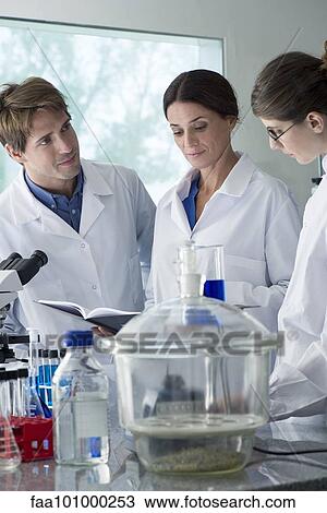 Scientists conducting experiment in laboratory View Large Photo Image Stock Image - Scientists conducting experiment in laboratory. Fotosearch