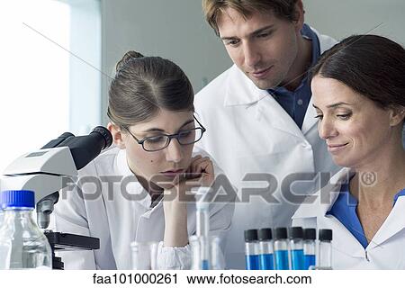 Scientists conducting experiment in laboratory View Large Photo Image Stock Image - Scientists conducting experiment in laboratory. Fotosearch