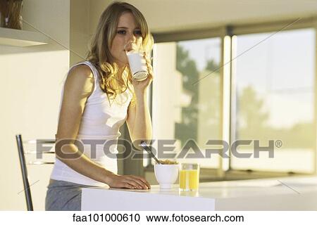 "Teenage girl at breakfast table, drinking glass of milk" View Large Photo Image Stock Image - "Teenage girl at breakfast table, drinking glass of milk". Fotosearch
