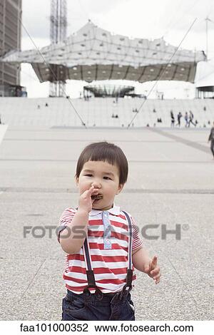 Toddler boy eating cookie outdoors View Large Photo Image Stock Image - Toddler boy eating cookie outdoors. Fotosearch