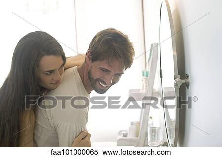 Woman embracing husband from behind View Large Photo Image Stock Photography - Woman embracing husband from behind. Fotosearch