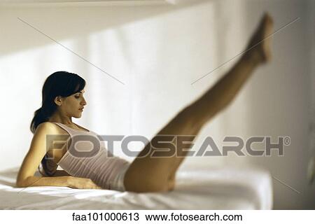 Woman on bed doing strengthening exercises View Large Photo Image Stock Image - Woman on bed doing strengthening exercises. Fotosearch
