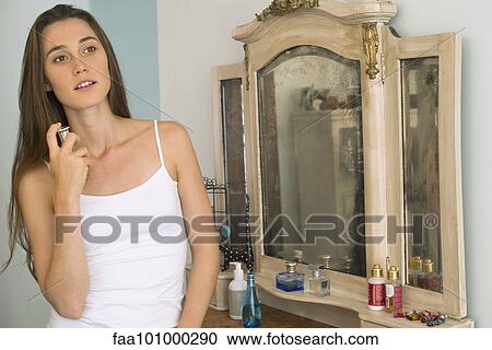 Woman putting on perfume View Large Photo Image Stock Image - Woman putting on perfume. Fotosearch