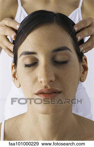 Stock Photo - "Woman receiving head massage, close-up". Fotosearch