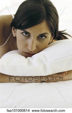 "Woman resting head on pillow, looking at camera, portrait" View Large Photo Image Picture - "Woman resting head on pillow, looking at camera, portrait". Fotosearch