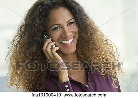 Stock Image - "Woman talking on cell phone, smiling cheerfully". Fotosearch