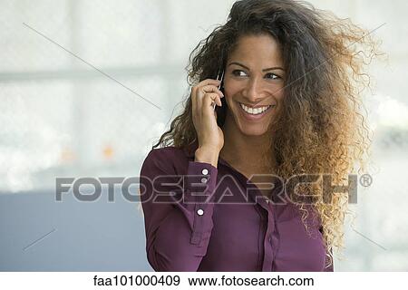 "Woman talking on cell phone, smiling cheerfully" View Large Photo Image Stock Photo - "Woman talking on cell phone, smiling cheerfully". Fotosearch