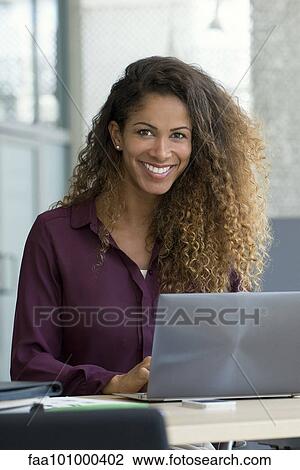 Woman using laptop computer in office View Large Photo Image Stock Image - Woman using laptop computer in office. Fotosearch