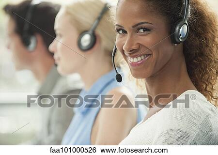 "Woman working in call center, smiling cheerfully" View Large Photo Image Stock Photograph - "Woman working in call center, smiling cheerfully". Fotosearch