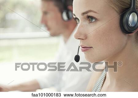 Stock Image - Woman working in call center. Fotosearch