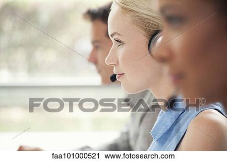 Stock Image - Woman working in call center. Fotosearch