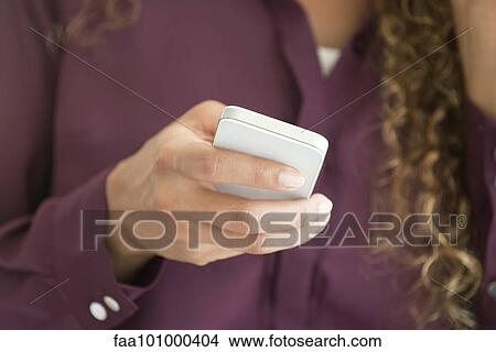 Woman's hand holding smartphone View Large Photo Image Picture - Woman's hand holding smartphone. Fotosearch