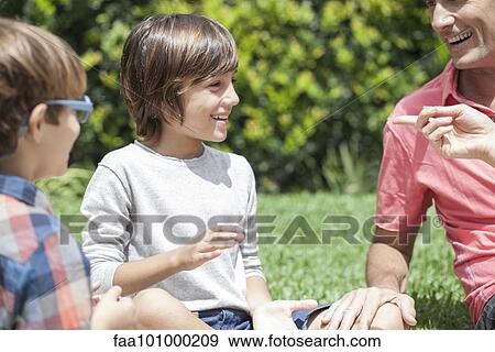 Young boys enjoying outdoor recreation with parents View Large Photo Image Stock Photo - Young boys enjoying outdoor recreation with parents. Fotosearch