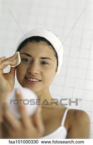 Young woman applying face powder View Large Photo Image Stock Image - Young woman applying face powder. Fotosearch