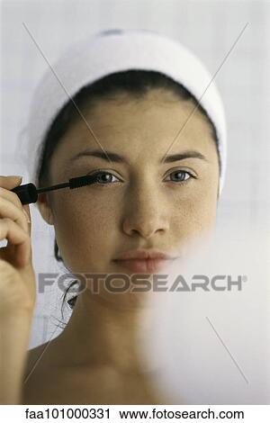 Young woman applying mascara View Large Photo Image Stock Image - Young woman applying mascara. Fotosearch