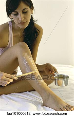 Young woman removing body hair with hot wax View Large Photo Image Stock Image - Young woman removing body hair with hot wax. Fotosearch