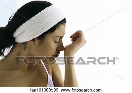 Stock Photo - Young woman trying on fragrance. Fotosearch