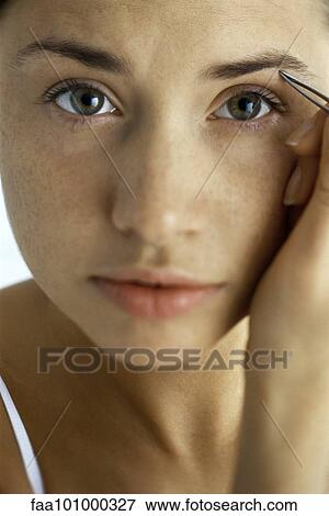"Young woman tweezing eyebrows, close-up" View Large Photo Image Stock Photo - "Young woman tweezing eyebrows, close-up". Fotosearch