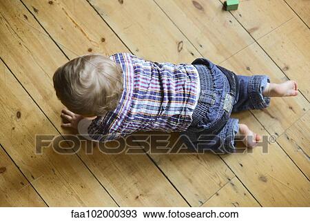 "Baby boy crawling on floor, overhead view" View Large Photo Image Stock Image - "Baby boy crawling on floor, overhead view". Fotosearch
