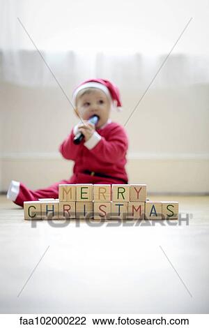 "Baby boy dressed as Santa Claus with toy blocks reading ""Merry Christmas""" View Large Photo Image Stock Image - "Baby boy dressed as Santa Claus with toy blocks reading ""Merry Christmas""". Fotosearch