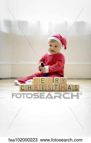 "Baby boy dressed as Santa Claus with toy blocks reading ""Merry Christmas""" View Large Photo Image Stock Image - "Baby boy dressed as Santa Claus with toy blocks reading ""Merry Christmas""". Fotosearch