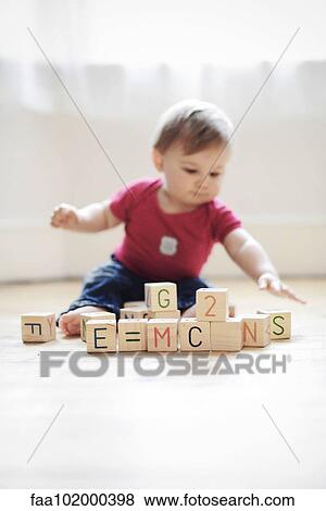 "Baby boy playing with toy blocks arranged to read ""E=mc2""" View Large Photo Image Stock Photo - "Baby boy playing with toy blocks arranged to read ""E=mc2""". Fotosearch