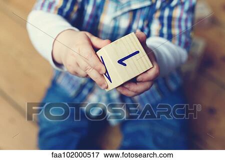 "Baby boy playing with wooden block, cropped" View Large Photo Image Stock Photo - "Baby boy playing with wooden block, cropped". Fotosearch