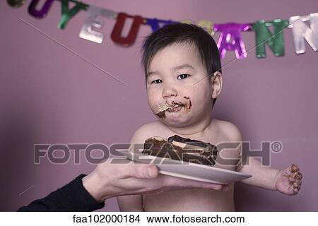 Baby eating birthday cake View Large Photo Image Picture - Baby eating birthday cake. Fotosearch