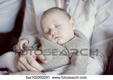 "Baby sleeping on mother's lap, cropped" View Large Photo Image Stock Image - "Baby sleeping on mother's lap, cropped". Fotosearch