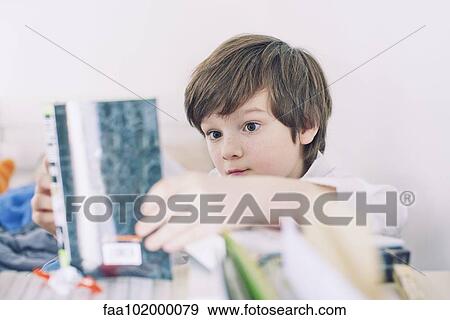 Boy reading book View Large Photo Image Stock Photo - Boy reading book. Fotosearch